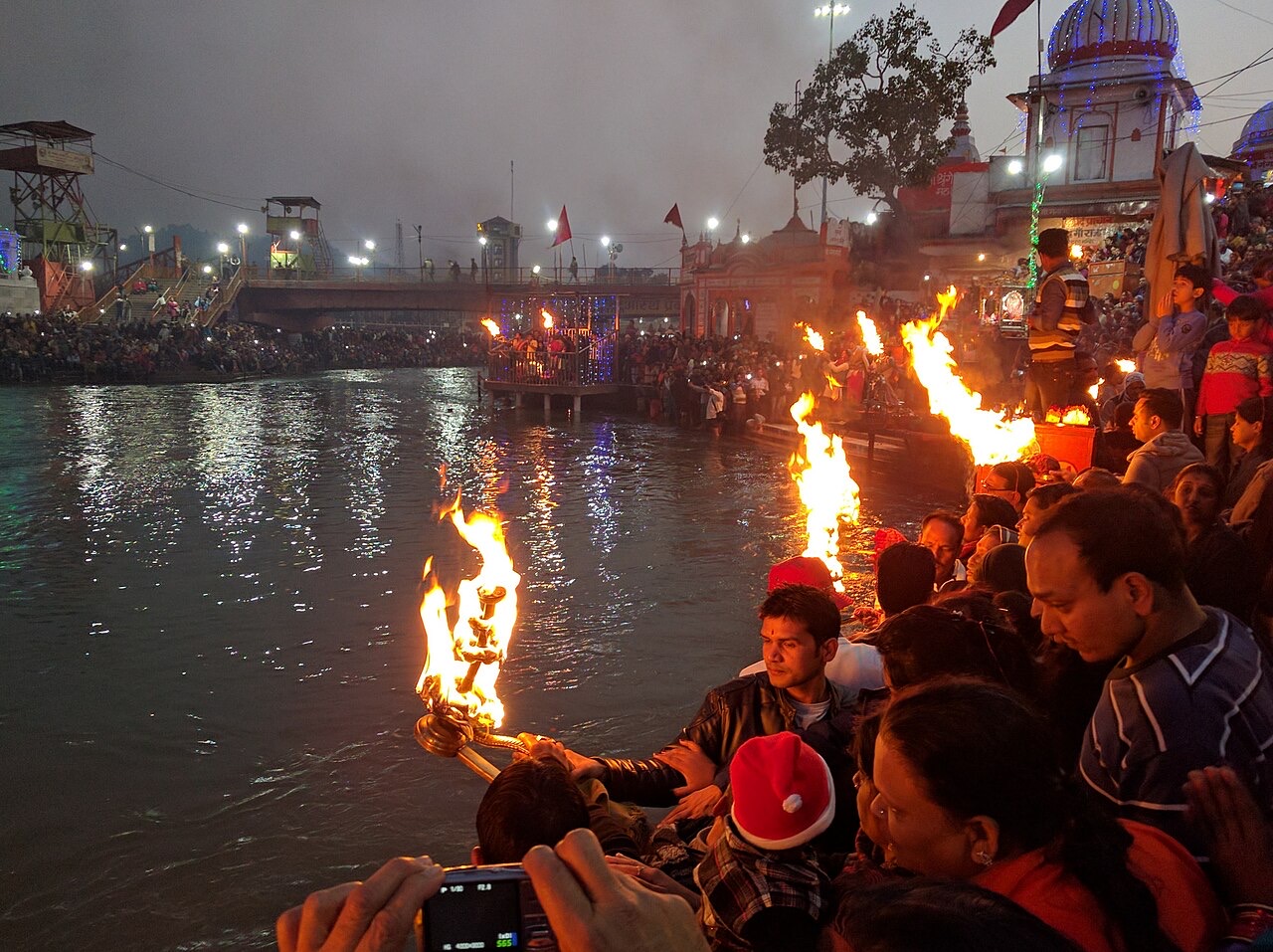 Devotees holding flaming lamps during the Ganga Aarti at Har Ki Pauri, Haridwar