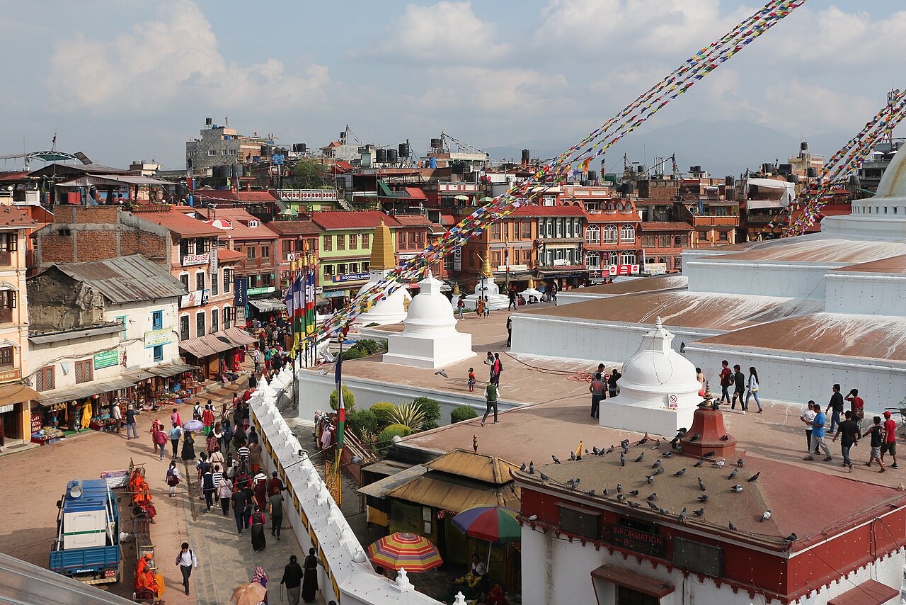 Pilgrims walking around the base of Boudhanath stupa in Kathmandu