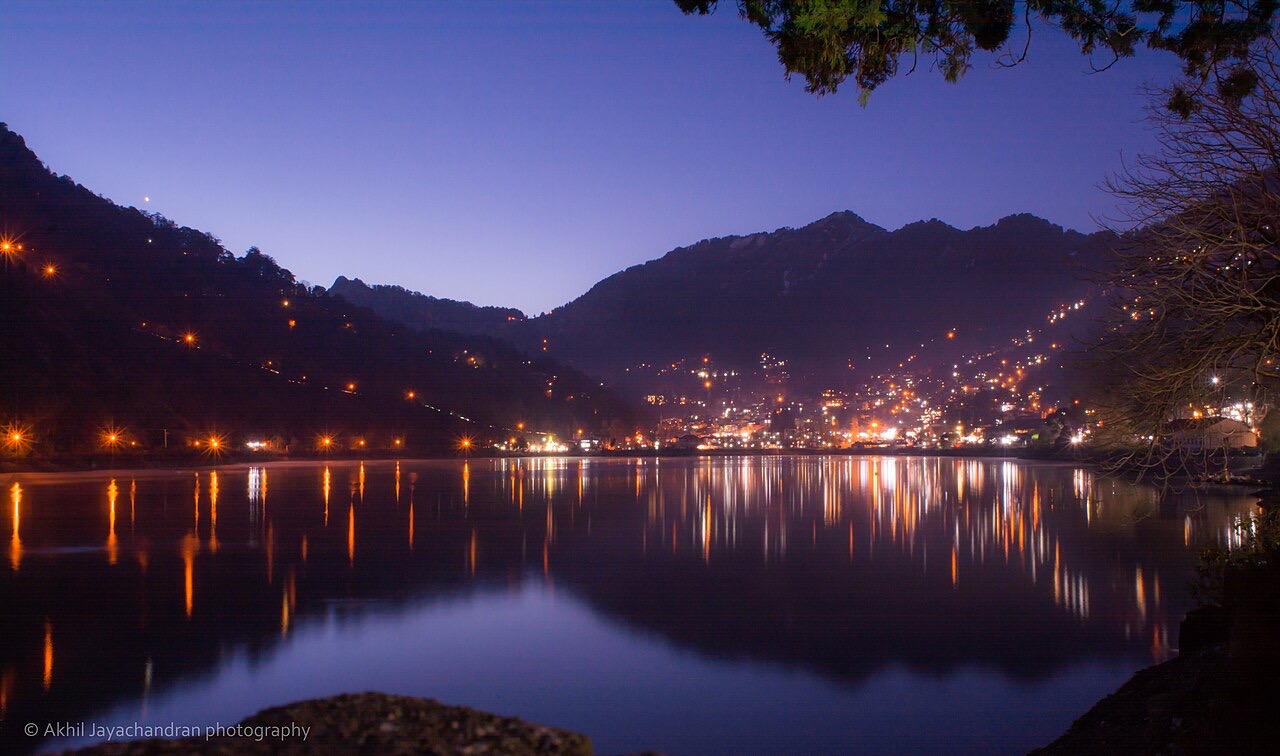 Lights of Nainital town reflected in Naini Lake at dusk