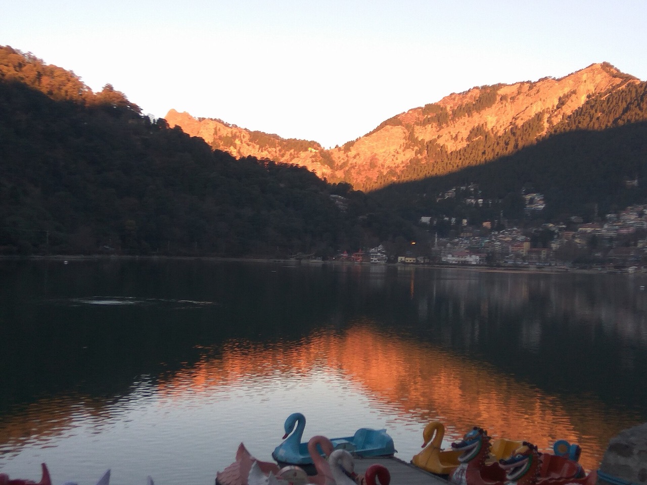Sunrise turning the hills above Naini Lake in Nainital a warm orange